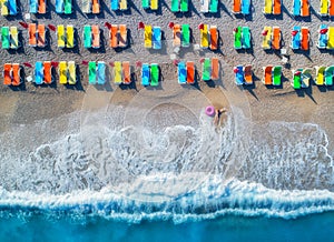 Aerial view of lying woman with swim ring in the sea