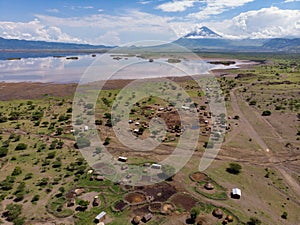 Aerial view of Maasai boma or family rural village on the coast of Salty lake Natron in the Great Rift Valley, Tanzania
