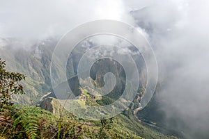 Aerial view of Machu Picchu Inca citadel in the clouds, located on a mountain ridge above the Sacred Valley