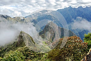 Aerial view of Machu Picchu Inca citadel in the clouds, located on a mountain ridge above the Sacred Valley