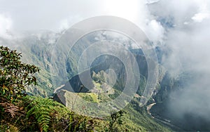 Aerial view of Machu Picchu Inca citadel in the clouds, located on a mountain ridge above the Sacred Valley