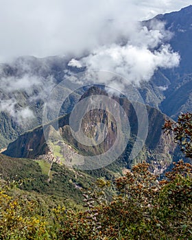 Aerial view of Machu Picchu Inca citadel in the clouds, located on a mountain ridge above the Sacred Valley