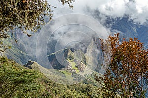 Aerial view of Machu Picchu Inca citadel in the clouds, located on a mountain ridge above the Sacred Valley