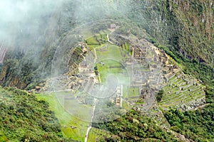 Aerial view of Machu Picchu Inca citadel ruins built in the classical Inca style, with polished dry-stone walls