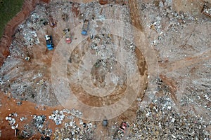 Aerial view made by drone of trucks unloading debris at the Landfill