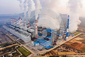 Aerial view of Mae Moh Coal Power Plant with smoke and toxic air from chimney. Factory industry. Electricity tower in energy or