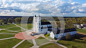 Aerial View Majestic Aglona Cathedral in Latvia. White Chatolic Church Basilica. Sunny Spring Day Blue Sky and White Clouds.