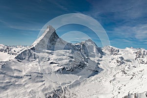 Aerial view of majestic Matterhorn mountain in front of a blue sky