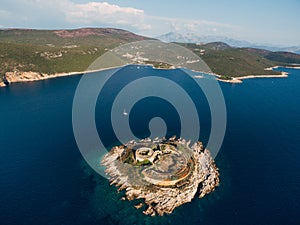 Aerial view of the Mamula fortress on the island against the backdrop of the mountains of Montenegro