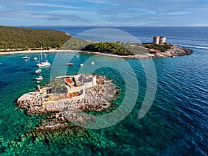 Aerial view of Mamula fortress on a rocky island with Arza Fortress in the background