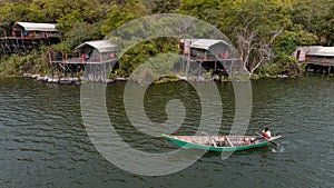 Aerial view of a man sailing a boat near the Wag Hill lodge and spa on the shore of Lake Victoria