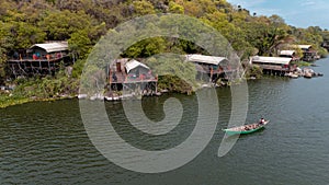 Aerial view of a man sailing a boat near the Wag Hill lodge and spa on the shore of Lake Victoria