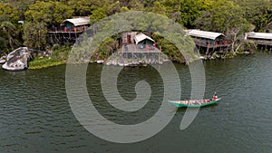 Aerial view of a man sailing a boat near the Wag Hill lodge and spa on the shore of Lake Victoria