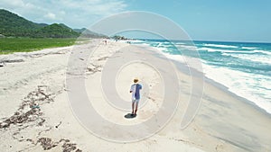 Aerial view of a man walking on the beach