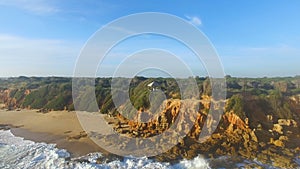 Aerial view of man in a wood stall near to a cliff and the sea