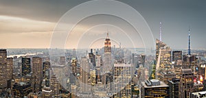 Aerial view of Manhattan skyline in New York City at sunset with the city lights.