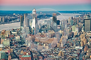 Aerial view of Manhattan West Side skyline along Hudson River at sunset. Hudson Yards on the background