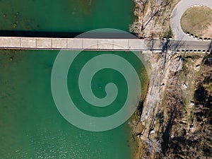 Aerial view of Mansfield Dam with crystal-clear blue water on a sunny day