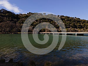 Aerial view of Mansfield Dam with crystal-clear blue water on a sunny day