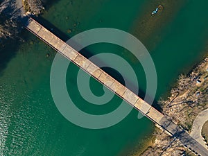 Aerial view of Mansfield Dam with crystal-clear blue water on a sunny day