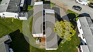 Aerial View of a Manufactured, Mobile, Prefab Double Wide Home Being Installed in a Lot in a Park