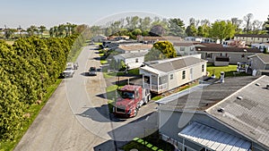 Aerial View of a Manufactured, Mobile, Prefab Double Wide Home Being Installed in a Lot in a Park