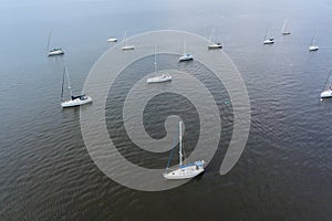 Aerial view of many boats in ocean near American harbor
