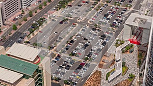 Aerial view of many colorful cars parked on parking lot with lines and markings for parking places all day timelapse