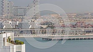 Aerial view of many luxury villas and hotels on the Palm Jumeirah island in Dubai timelapse. UAE