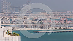 Aerial view of many luxury villas and hotels on the Palm Jumeirah island in Dubai timelapse. UAE