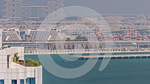 Aerial view of many luxury villas and hotels on the Palm Jumeirah island in Dubai timelapse. UAE