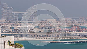 Aerial view of many luxury villas and hotels on the Palm Jumeirah island in Dubai timelapse. UAE