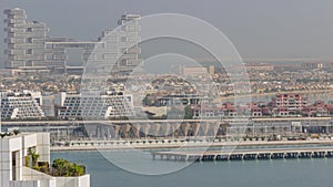 Aerial view of many luxury villas and hotels on the Palm Jumeirah island in Dubai timelapse. UAE