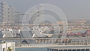 Aerial view of many luxury villas and hotels on the Palm Jumeirah island in Dubai timelapse. UAE