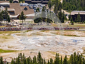 Aerial view of many people waiting for the Old Faithful geyser hot water eruptions