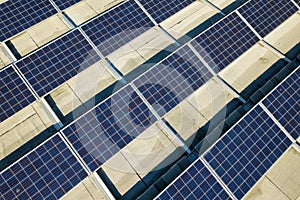 Aerial view of many photo voltaic solar panels mounted of industrial building roof