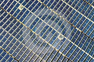 Aerial view of many photo voltaic solar panels mounted of industrial building roof