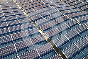 Aerial view of many photo voltaic solar panels mounted of industrial building roof