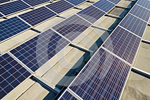 Aerial view of many photo voltaic solar panels mounted of industrial building roof