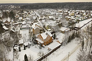 Aerial view on many snowy houses in Russian village. Russian winter countryside landscape