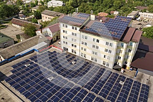 Aerial view of many solar panels mounted of industrial building roof