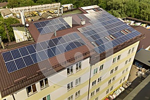 Aerial view of many solar panels mounted of industrial building roof