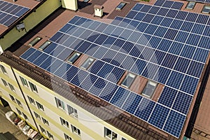 Aerial view of many solar panels mounted of industrial building roof