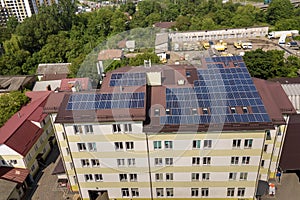 Aerial view of many solar panels mounted of industrial building roof