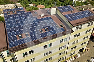 Aerial view of many solar panels mounted of industrial building roof