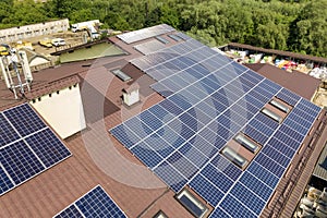 Aerial view of many solar panels mounted of industrial building roof