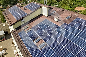 Aerial view of many solar panels mounted of industrial building roof