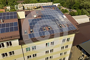 Aerial view of many solar panels mounted of industrial building roof