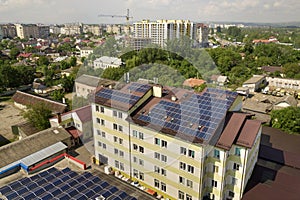 Aerial view of many solar panels mounted of industrial building roof