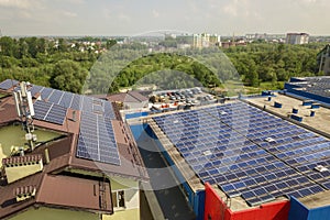 Aerial view of many solar panels mounted of industrial building roof